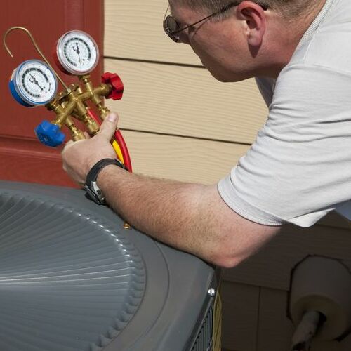 An HVAC Technician Tests an Air Conditioner.