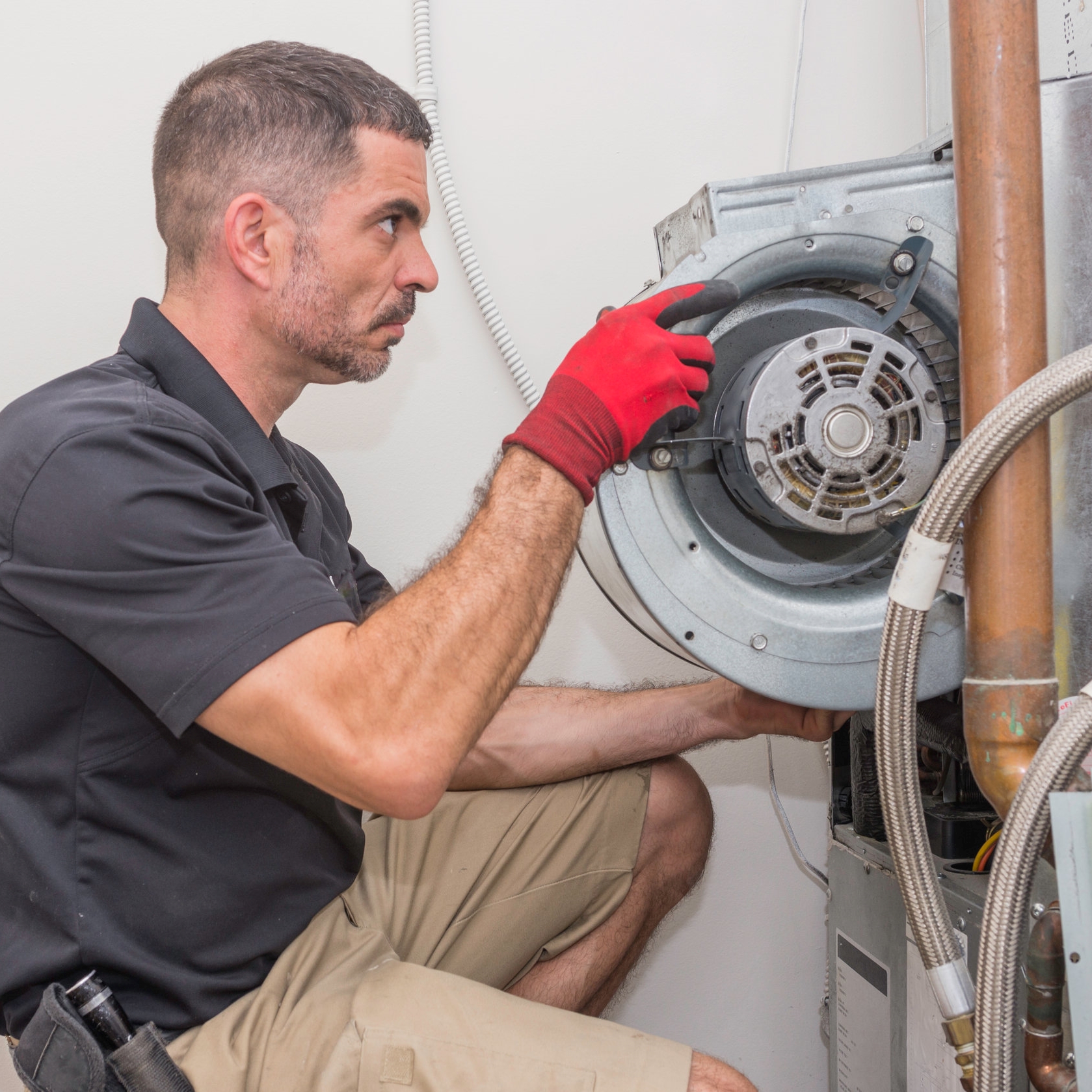 An HVAC Technician Installs a Blower.